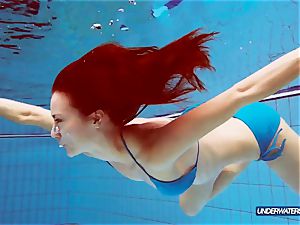 red-haired in blue bikini flashing her body